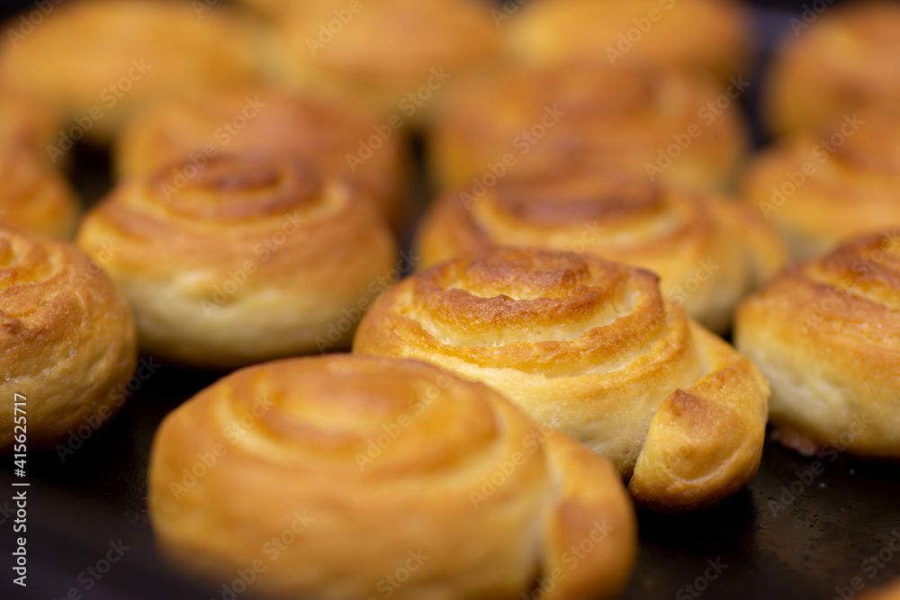 baking sweet buns in the oven close-up. the selected focus.
