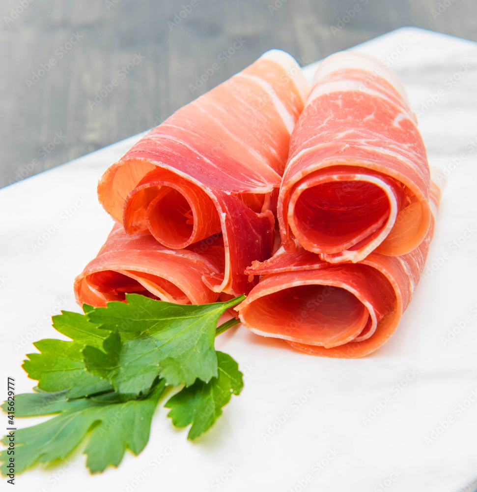 marble dish with raw ham slices