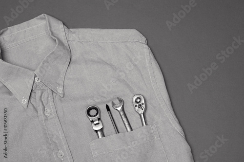 Mechanic Tools In The Pocket Of A Collared Shirt Worker.