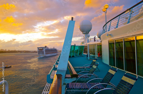 Pooldeck or swimmingpool with outdoor sun deck on modern classic cruiseship or cruise ship liner with sun loungers and deck chairs photo