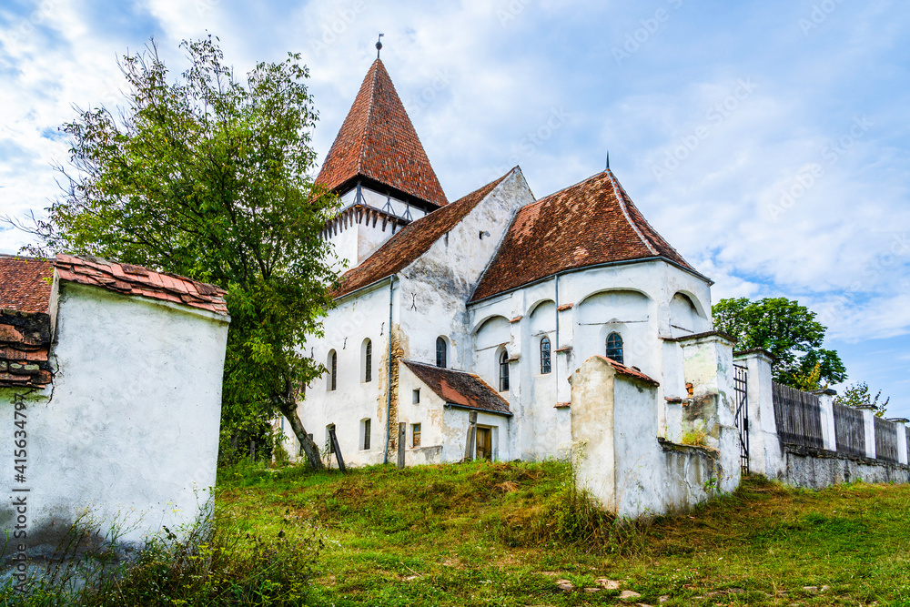 Fototapeta premium Medieval evangelical saxon fortified church of Somartin village (Martinsberg), Bruiu commune, Sibiu county, Transylvania, Romania; Saxon fortified church of Transylvania