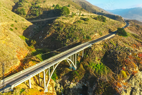 Aerial view from a drone, Bixby Creek Bridge on Highway One on the US West Coast heading south to Los Angeles, Big Sur, California, beautiful scenery, cliffs, Pacific Ocean. Concept, vacation, tourism photo