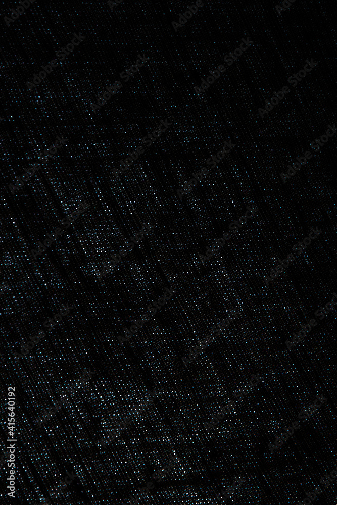 abstract rough dark background of linen natural fabric on the light, short focus