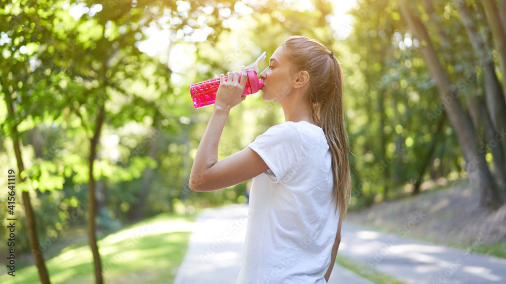 Woman drink water red bottle after morning workout. Woman drink water red bottle after morning workout.