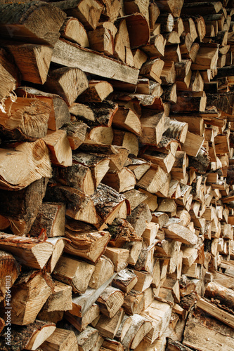 Pile of stacked triangle firewood prepared for fireplace and boiler. High quality photo