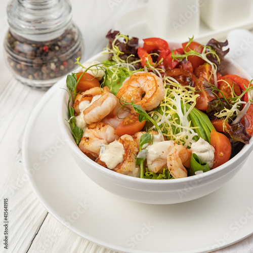 Seafood salad on a white wooden table
