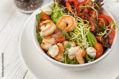 Seafood salad on a white wooden table
