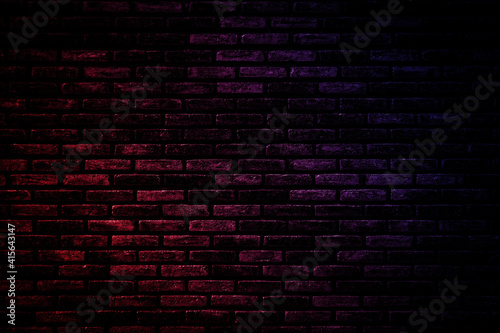 Neon light on brick walls that are not plastered background and texture. Lighting effect red and blue neon background vertical of empty brick basement wall.