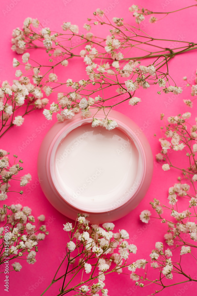 Cream for face in flowers . Face cream on a pink background. Skin care. The beauty industry. Copy space. White flowers. Article about the right choice of cream. Selection of the cream. Spa treatments. Cream for face in flowers . Face cream on a pink background. Skin care. The beauty industry. Copy space. White flowers. Article about the right choice of cream. Selection of the cream. Spa treatments.