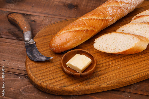 Fresh baguette bread on wooden background