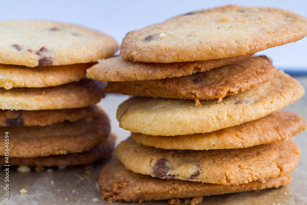 Two stacks of homemade chocolate chip cookies with crumbs Two stacks of homemade chocolate chip cookies with crumbs