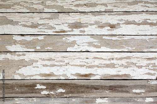 The texture of an old wooden wall with peeling paint. Boards with peeling white paint. Texture, background