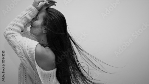 Woman's hair blowing in the studio - moody portraits