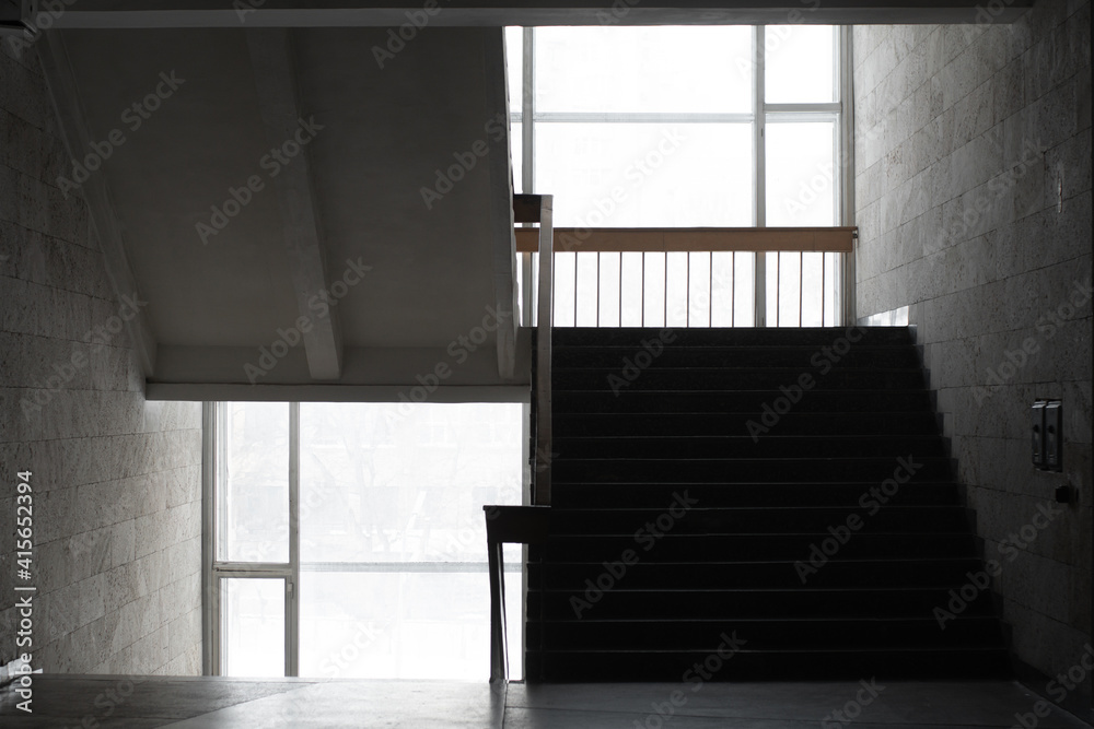 Empty minimalist staircase in soviet modernism style interior. In the afternoon with a white background outside the windows. Empty minimalist staircase in soviet modernism style interior. In the afternoon with a white background outside the windows.