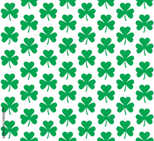 Vector seamless pattern of flat green shamrock clover isolated on white background 
