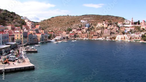 Symi Greece Rhodes is a Greek island It is mountainous and includes the harbor town of Symi and its adjacent upper town Ano Symi, with beautiful neoclassical uniform and colorful houses photo