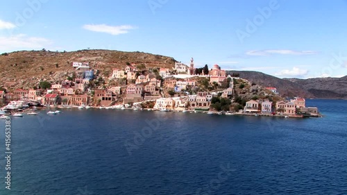 Symi Greece Rhodes is a Greek island It is mountainous and includes the harbor town of Symi and its adjacent upper town Ano Symi, with beautiful neoclassical uniform and colorful houses photo