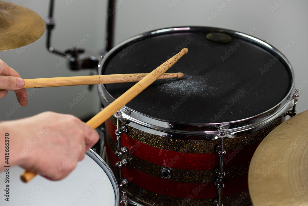 Professional drum set closeup. Man drummer with drumsticks playing drums and cymbals, on the live music rock concert or in recording studio Professional drum set closeup. Man drummer with drumsticks playing drums and cymbals, on the live music rock concert or in recording studio