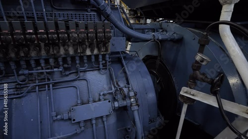 Gear of shaft generator next to main engine of ship
