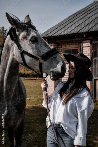 Cowboy girl in a cowboy hat with horse  © Jelena
