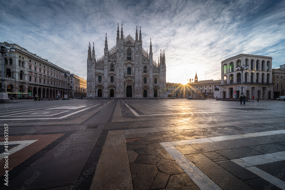 Beautiful scenic picture of Piazza Duomo of Milan Italy at sunrise and sun star