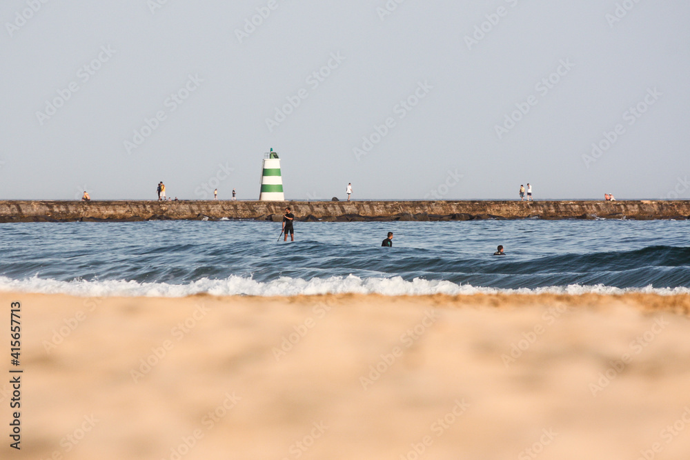 Fototapeta premium Lighthouse on the beach, Praia da Rocha, Algarve, Portugal