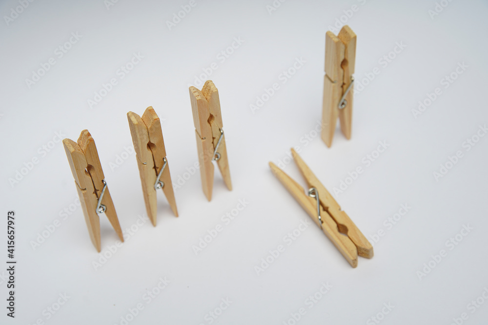 Wooden clothespin isolated on a withe background. The clothespin is a fastener used to dry clothes. Wooden clothespin isolated on a withe background. The clothespin is a fastener used to dry clothes.