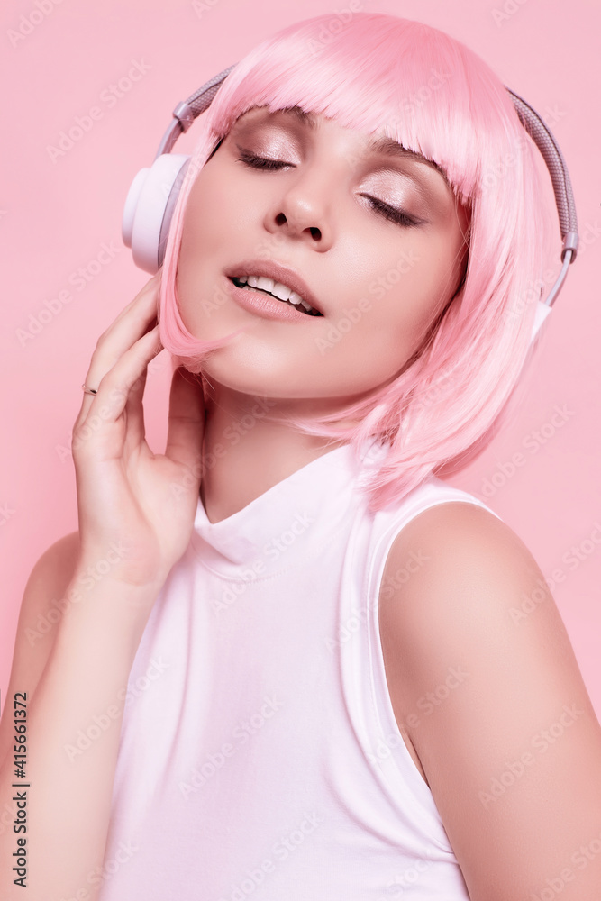 Bright sexy hipster girl with pink hair enjoys the music in headphones Bright sexy hipster girl with pink hair enjoys the music in headphones