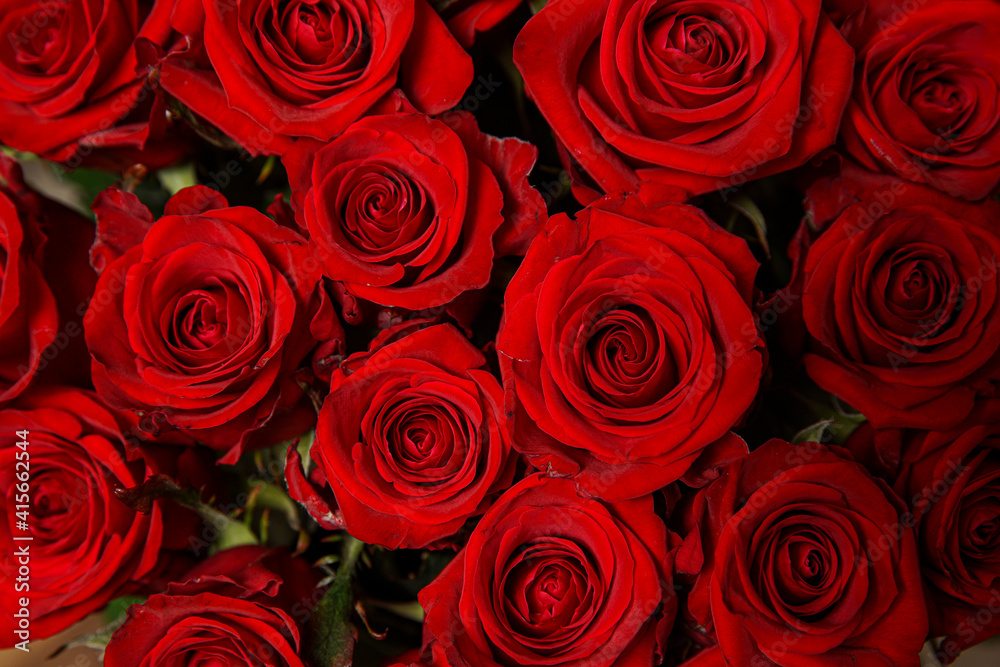 Beautiful bouquet of red roses, seen from above. Spring flowers. Wedding, women's day, mothers day and valentines day background. Selective shallow depth of field.