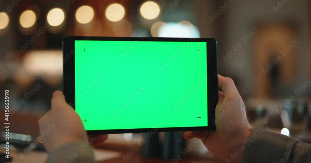 Hands holding tablet pc with green chroma key mock up display. Digital device used for watching a video, having online chat or surfing web in cafe - technology 4k footage Hands holding tablet pc with green chroma key mock up display. Digital device used for watching a video, having online chat or surfing web in cafe - technology 4k footage