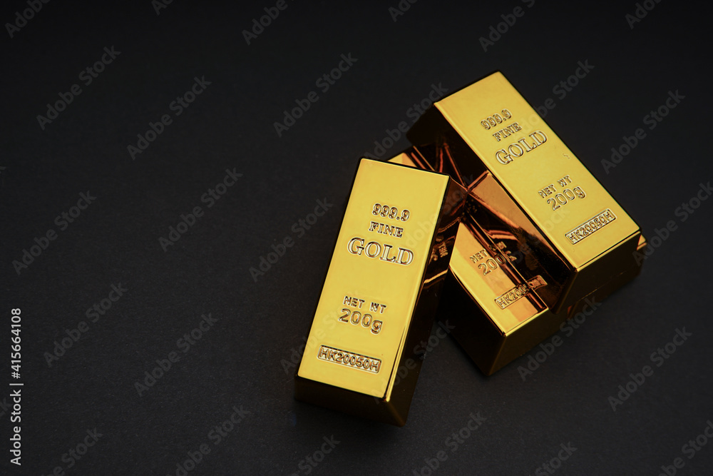 a pile of gold bar on a black background. Shiny precious metals for investments or reserves. Place for text. a pile of gold bar on a black background. Shiny precious metals for investments or reserves. Place for text.