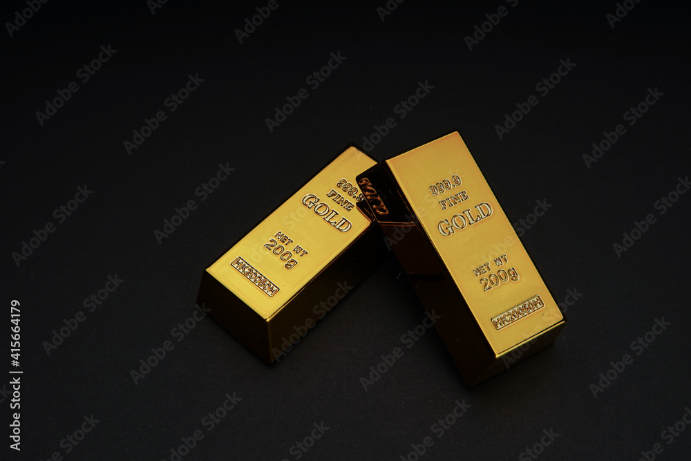 two gold bars on a black background. Shiny precious metals for investments or reserves. Place for text. two gold bars on a black background. Shiny precious metals for investments or reserves. Place for text.