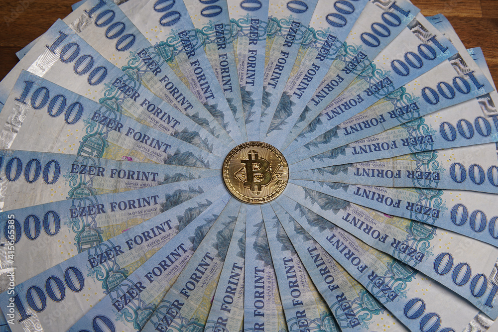 Pile of 1000 Hungarian forints, round. Multiple gold bitcoin digital cryptocurrency coins scattered. Bank image and photo background. Pile of 1000 Hungarian forints, round. Multiple gold bitcoin digital cryptocurrency coins scattered. Bank image and photo background.