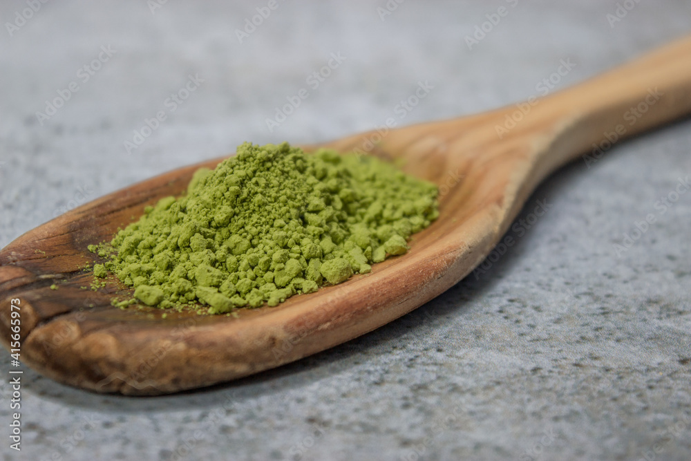 Horizontal image of a detail of many matcha tea in powder on top of a wooden cooking stick. Matcha tea preparation 2021. Horizontal image of a detail of many matcha tea in powder on top of a wooden cooking stick. Matcha tea preparation 2021.