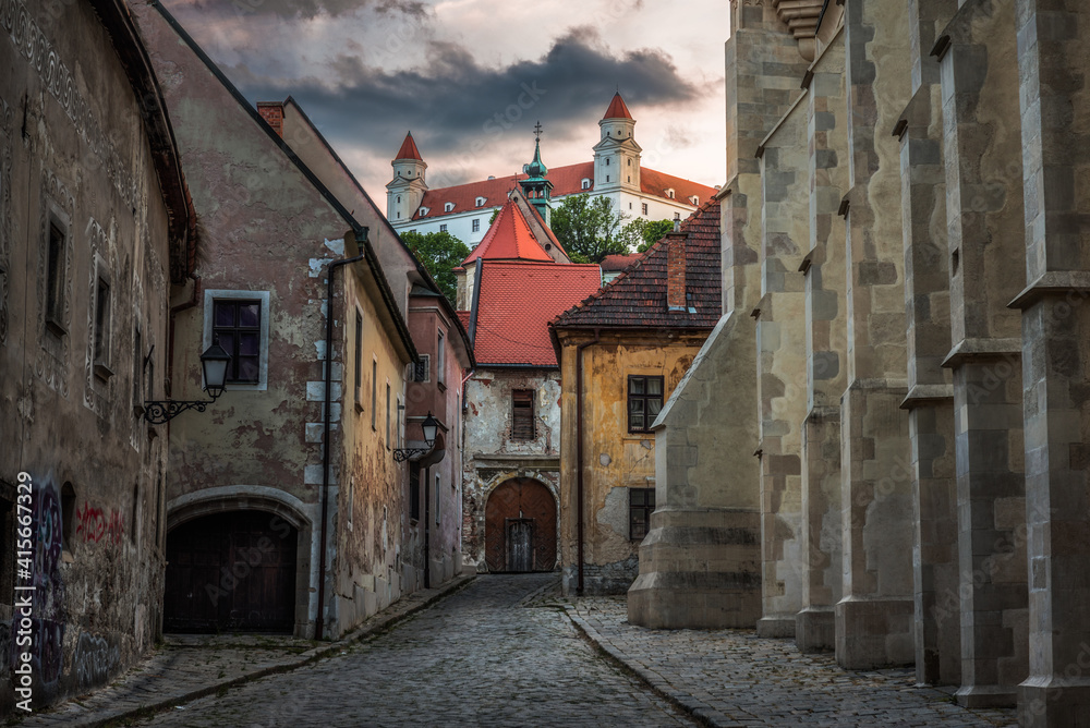 Farska Street in Historical Centre of Bratislava, Slovakia at Sunset with Bratislava Castle in Background