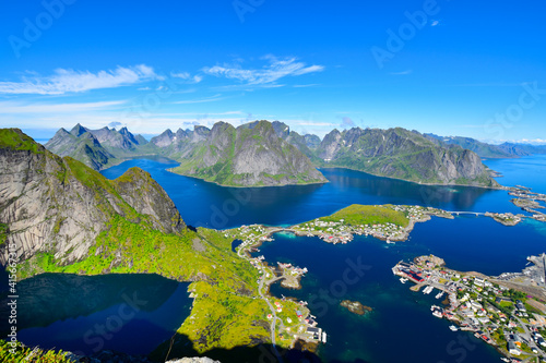 Fototapeta Naklejka Na Ścianę i Meble -  Stunning view point of mountains and blue sea at Reinebringen, Lofoten islands. Scenery of Reine fishing village. One of most popular hiking trails in North of Norway. Nature background