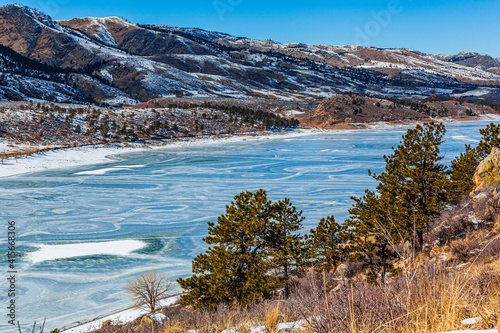 Frozen mountain reservoir in winter on a sunny day