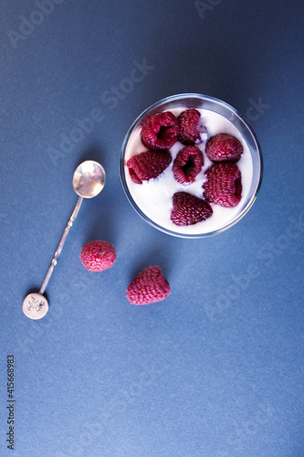 Glass with yogurt and raspberries