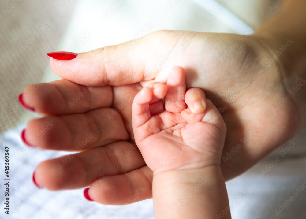 Close up of mother and child hands, love and security Close up of mother and child hands, love and security