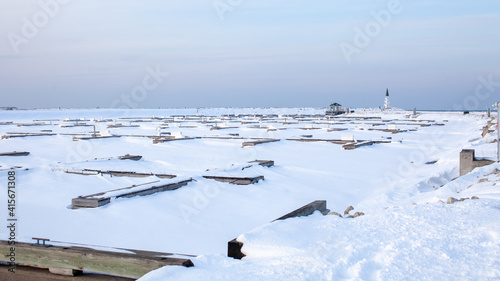 The frozen in slips at the private marina at Lighthouse Point, in Collingwood, sits empty all winter, waiting for the bay the thaw and the boats to launch in the spring in Georgian Bay photo