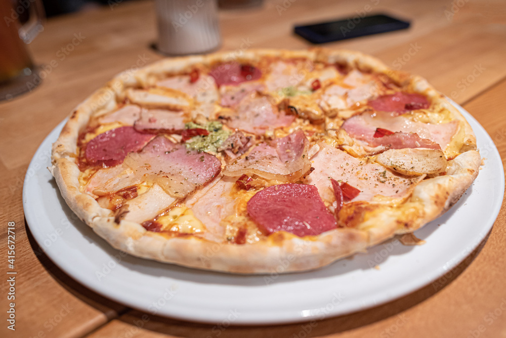 Appetizing pizza on a plate on the table. Appetizing pizza on a plate on the table.