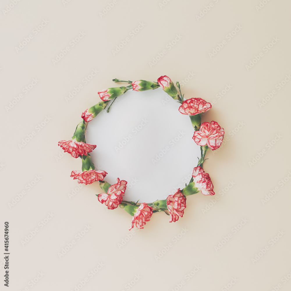 Obraz premium Wreath made of carnation on pastel background. Festive floral frame with space for text.