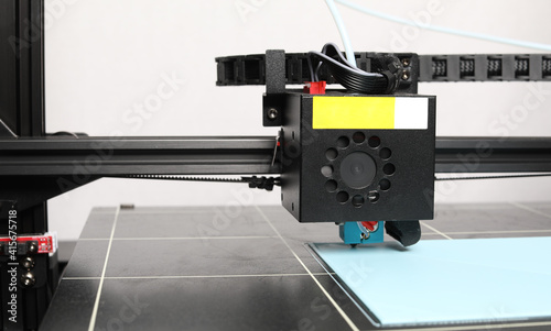 3D printer printing on a grid surface