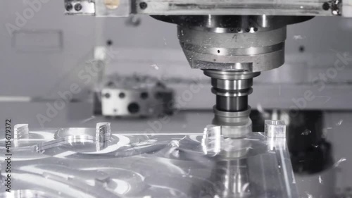Automated Programmed CNC vertical milling machine with face mill shell endmill tool in process over aluminum metal piece, Industrial Factory 4k. photo