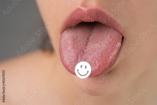 Drug addiction. Tongue with drugs. LSD. Psychedelic hallucinogens.