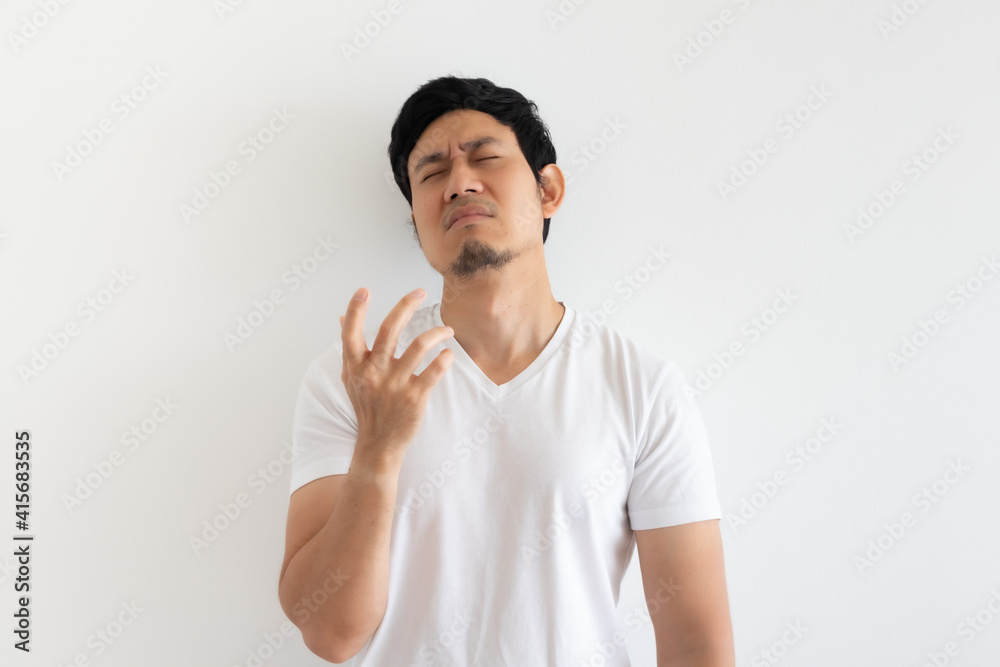 Serious and upset Asian man wears white t-shirt isolated on white background. Serious and upset Asian man wears white t-shirt isolated on white background.