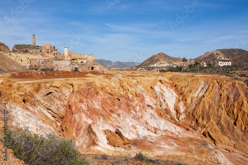 Eroded orange mountains in an abandoned mine