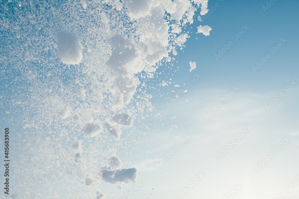 snow splash in the air, blue sky background