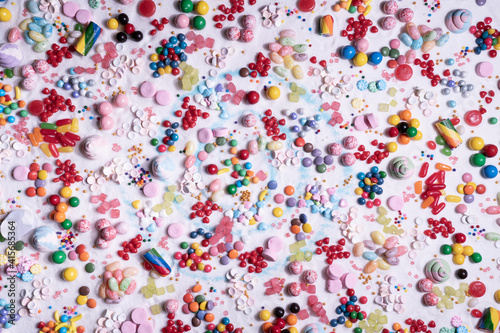 Chocolate coated and jelly beans candy mix. Big explosion of variety colour snack and sugar confetti. Festive dessert of different kinds of soft gummy, lollipop for holiday.