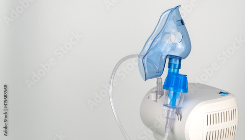 nebulizer and breathing mask on a white background. treatment of respiratory diseases and allergies